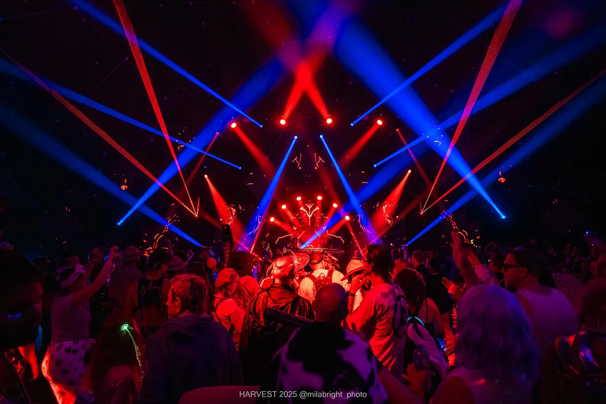 Crystal Six festival crowd bathed in red and blue laser lights