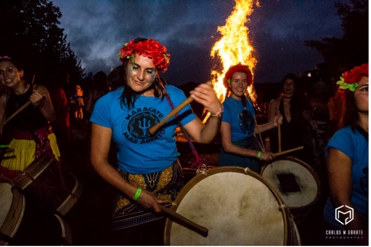 Drummers with bonfire behind them