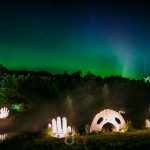 Northern lights appear over art statues
