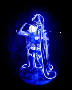 art-installation-tallandvibin Futuristic blue robot statue with glowing lights drinking from a sphere