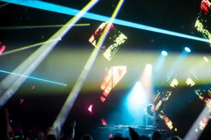 beth-lydi-abstract-tallandvibin DJ performing on stage with blue stage lights