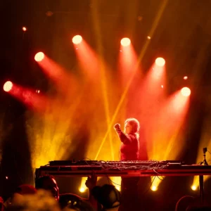 beth-lydi-tallandvibin DJ performing on stage with red and yellow stage lights