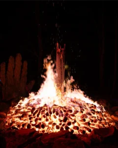 bonfire-morning-tallandvibin Bonfire after hours of being lit reduced to a glow and one upright log