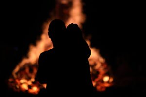 couple-by-the-bonfire Couple by bonfire