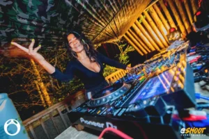 dj-ANNA MORGAN-by-zac-mac. DJ at booth with hand in the air