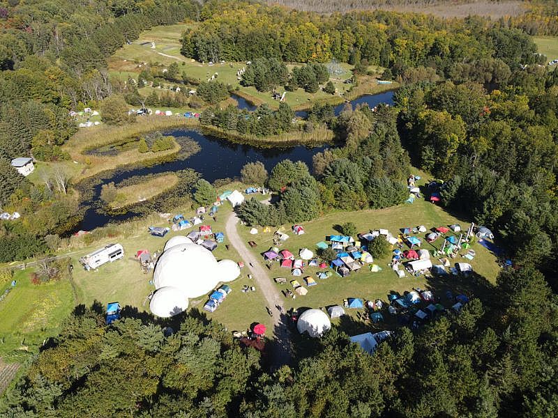 Looking east from drone of tents and stage