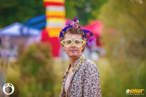 dude-glow-glasses-by-zac-mac Man with butterfly headband and heart glasses at outdoor festival