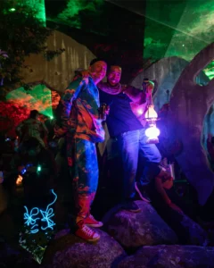 dudes-by-head-tallandvibin Two men with colourful outfits and glowing lanterns at a night festival