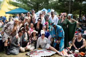 group-shot-tallandvibin Group of people in colourful robes and head wraps at an outdoor festival