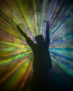 rays-around-person-tallandvibin Silhouette of a dancer with colourful rays behind