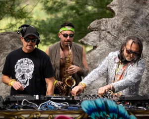 two-djs-sax-tallandvibin DJs and saxophonist perform at an outdoor music festival